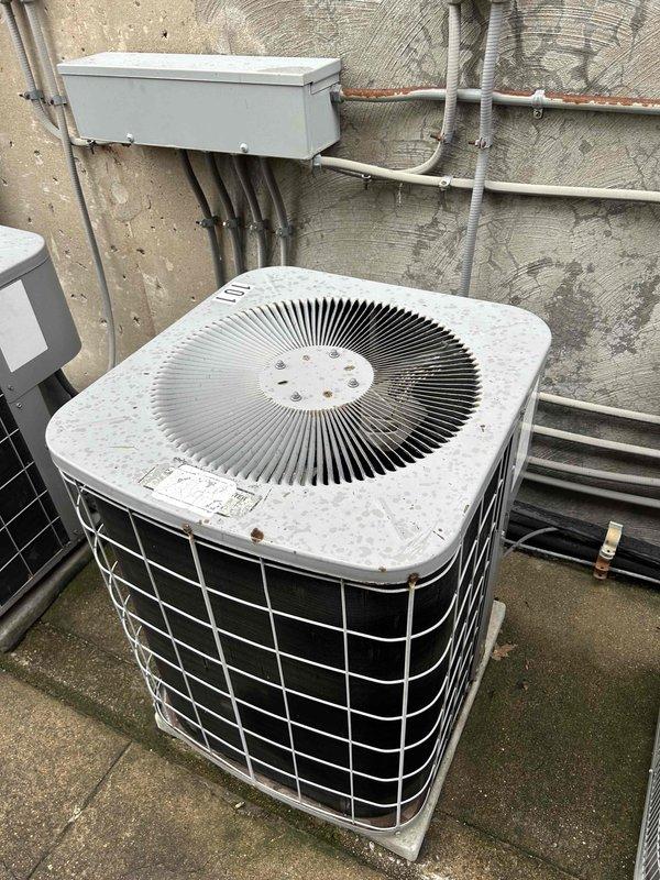 Responded to service call for water leak on 20-year-old electric HVAC system with indoor unit located inside front door. Upon inspection, discovered evaporator coil completely frozen with thick ice accumulation across all fins, indicating restricted airflow as primary cause of condensation leak. Assessed outdoor condenser unit showing signs of age and weathering but operational. Diagnosed frozen coil condition likely caused by combination of dirty/restricted evaporator coil, possible low refrigerant charge, and inadequate airflow from neglected filter maintenance. Documented extensive frost buildup on coil surfaces and overall system condition with photographic evidence. Advised that system requires coil cleaning, refrigerant charge verification, and regular filter maintenance to prevent recurrence of freezing and water leak issues.