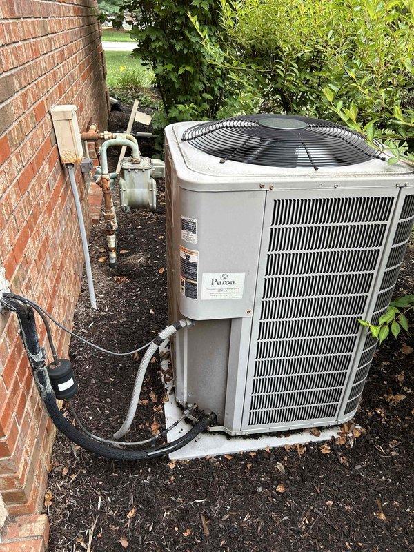 Responded to no cooling complaint on 20+ year old Payne electric HVAC system. Performed diagnostic evaluation of outdoor condenser unit and indoor air handler located in basement. System assessed for refrigerant levels, electrical components, compressor operation, and airflow restrictions. Photos documented equipment condition including outdoor unit placement, refrigerant line connections, and indoor air handler with associated ductwork. Customer advised of findings and repair options for aging system.