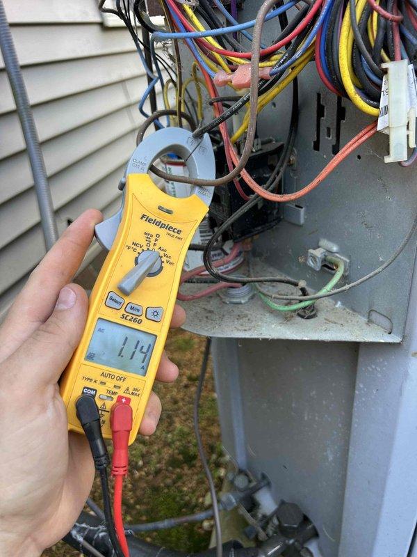 Completed maintenance tune-up on 10-year-old heat pump system with indoor unit located in attic. Performed electrical diagnostics using digital multimeter, verifying amperage readings and control circuit integrity at outdoor unit. Inspected A-frame evaporator coil assembly, noting rust staining at coil seam junction indicating historical moisture exposure; coils remain functional with adequate heat transfer capability.