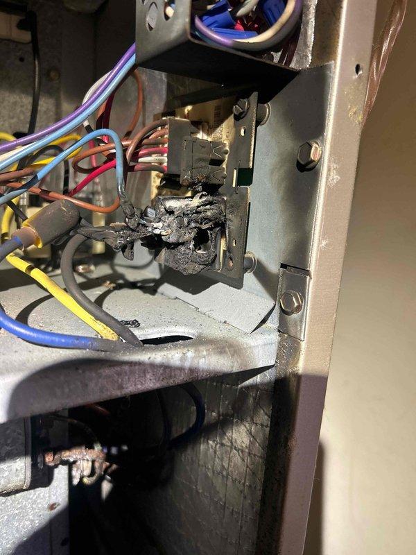 Responded to no cooling call on 13-year-old electric air conditioning system. Upon arrival, confirmed outdoor unit was not operating and indoor temperature was rising above setpoint. Visual inspection revealed catastrophic failure of contactor with severe burning and charring of electrical components. Additionally found extensive corrosion on compressor mounting hardware and deteriorated metal strapping, indicating prolonged exposure to moisture and lack of preventative maintenance. System was shut down to prevent further damage and eliminate burnt electrical odor from circulating through ductwork. Recommended complete contactor replacement and evaluation of compressor functionality once electrical components are restored, as well as assessment of outdoor unit structural integrity due to advanced corrosion.