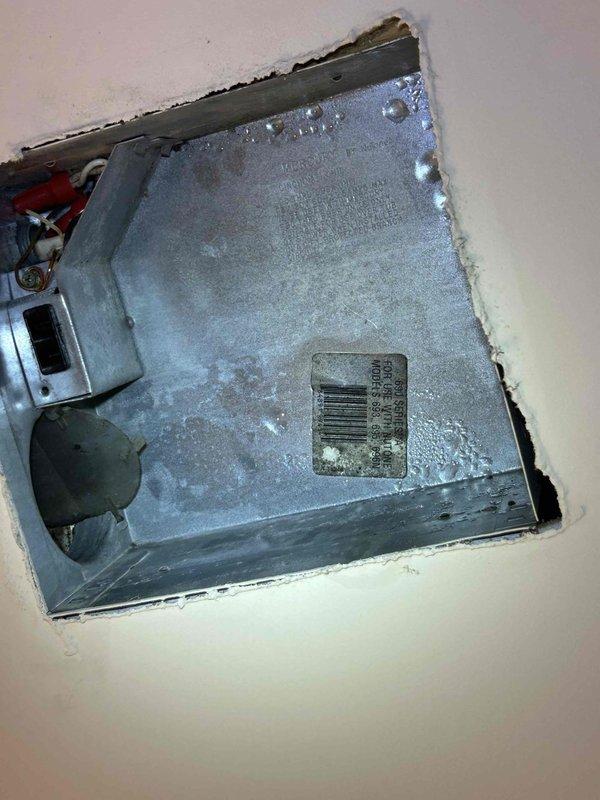 Responded to water leak complaint at second-floor bathroom ceiling vent in 3-story residential property with 10-year-old HVAC system and furnace located in attic space above affected area. Inspected bathroom exhaust vent housing and flexible ductwork, confirming moisture intrusion originated from HVAC condensate drainage issue rather than plumbing system. Documented conditions with photos showing vent assembly and interior duct surfaces with visible water staining and debris accumulation.