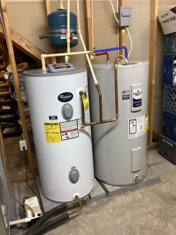 Disconnected and removed existing 50-gallon residential water heater from utility room. Installed new 50-gallon Whirlpool water heater in same location, connecting all copper supply and discharge lines with appropriate fittings and valves. Coordinated with geothermal system desuperheater pump shutdown and verified proper restart of pump operation prior to departure. Tested all connections for leaks, confirmed proper water flow, and ensured full functionality of new unit before completing installation.