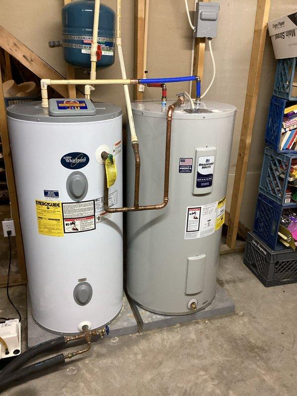 Disconnected and removed existing 50-gallon residential water heater from utility room. Installed new 50-gallon Whirlpool water heater in same location, connecting all copper supply and discharge lines with appropriate fittings and valves. Coordinated with geothermal system desuperheater pump shutdown and verified proper restart of pump operation prior to departure. Tested all connections for leaks, confirmed proper water flow, and ensured full functionality of new unit before completing installation.