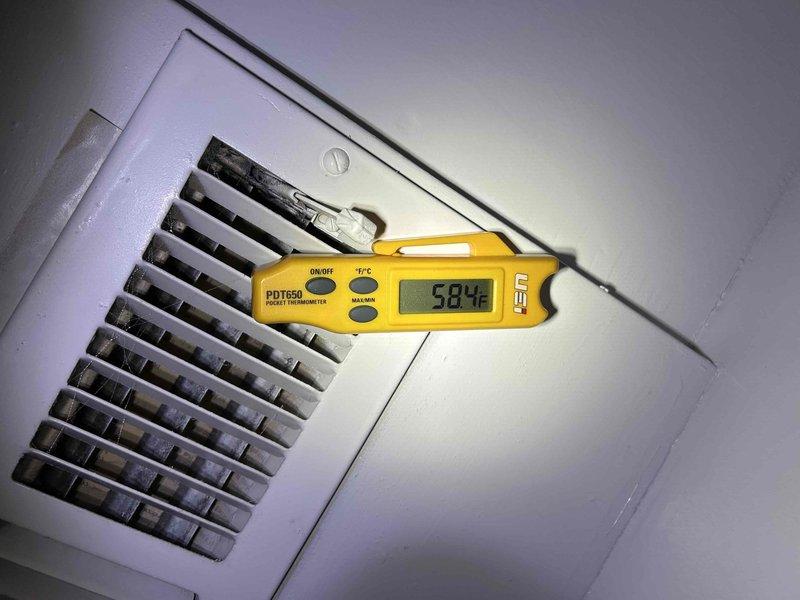 Completed HVAC maintenance inspection on air conditioning system. Measured supply air temperature at 58.4°F at ceiling register, checked system operation, and verified proper airflow through ventilation grille. Inspected air handler unit and confirmed 16x25x1 MR-13 Carbotron filter was in place and serviceable.