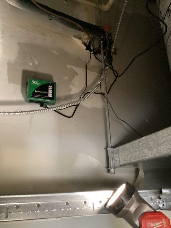 Installed Taco LeakBreaker 3/4" NPT water heater shut-off valve and actuator system on A.O. Smith water heater as part of warranty service. Device mounted and wired with indicator lights operational; however, possible recall identified requiring technician to return with replacement unit per management directive.