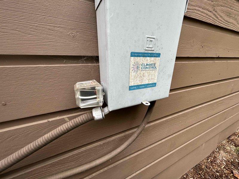 Responded to no-cooling call on 8-year-old electric heat pump system following lightning strike. Upon arrival, found thermostat completely blank with no power and outdoor unit non-operational while other system on property remained functional. Performed visual inspection of outdoor unit electrical components and disconnect box, documenting condition of wiring, capacitor, and control panel. Assessed lightning damage to electrical system components including control board, capacitor, and low-voltage wiring connections. Identified compromised electrical components requiring replacement to restore system operation and provided repair recommendations to restore cooling functionality.