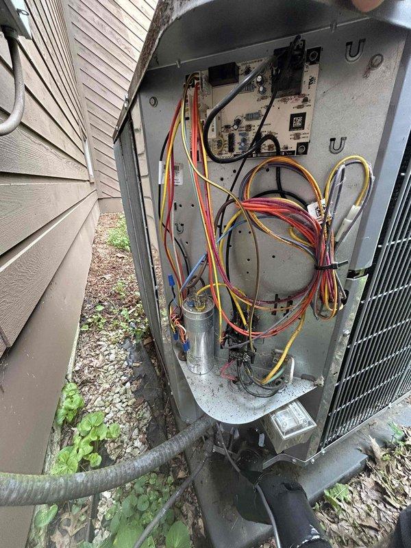 Responded to no-cooling call on 8-year-old electric heat pump system following lightning strike. Upon arrival, found thermostat completely blank with no power and outdoor unit non-operational while other system on property remained functional. Performed visual inspection of outdoor unit electrical components and disconnect box, documenting condition of wiring, capacitor, and control panel. Assessed lightning damage to electrical system components including control board, capacitor, and low-voltage wiring connections. Identified compromised electrical components requiring replacement to restore system operation and provided repair recommendations to restore cooling functionality.