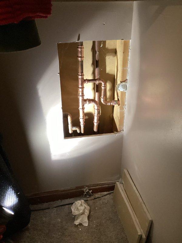 Responded to customer report of outdoor spigot not shutting off completely and unusually high water bill indicating possible leak. Accessed plumbing system through interior wall cavity to locate and repair malfunctioning outdoor spigot valve assembly. Cut access panel in interior wall to reach copper supply lines connected to exterior hose bib. Identified failed valve seat and internal components preventing complete water shutoff. Replaced defective valve mechanism and tested system to ensure proper shutoff function and eliminate leak. Restored water control to outdoor spigot, resolving high water consumption issue.