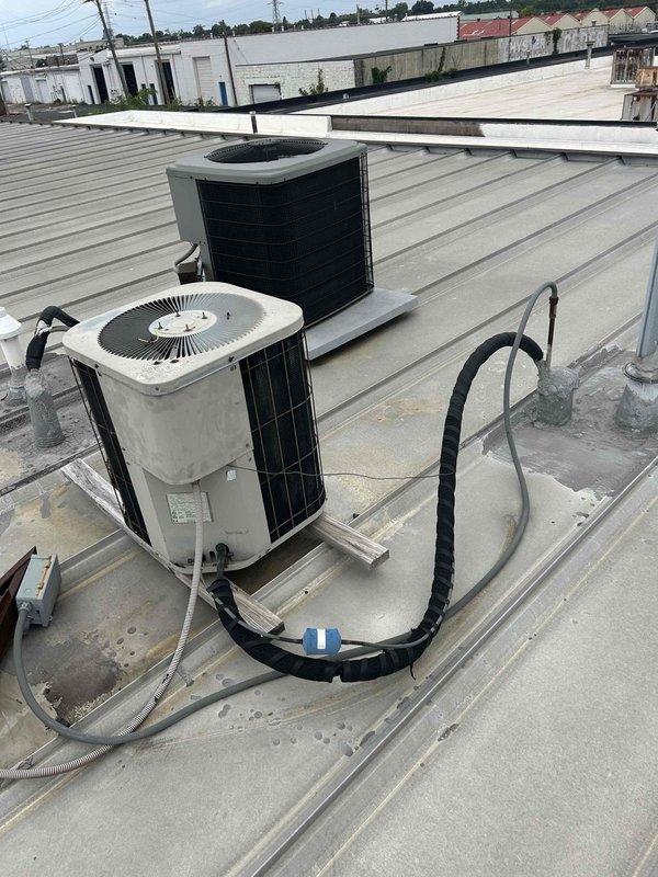 Responded to report of steady water drip from first-floor indoor unit that occurred overnight, with system shut down to prevent further leakage. Inspected rooftop HVAC equipment including condenser unit and refrigerant line set connections. Performed diagnostic assessment and weighed refrigerant charge using calibrated scale, measuring 3.0 pounds to verify system levels and identify potential causes of condensate overflow or drain line blockage.