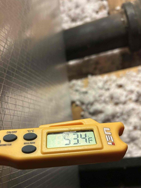Completed scheduled maintenance on a 15-year-old air conditioning system located in attic. Performed comprehensive AC tune-up with no prior reported issues. During inspection, observed significant frost and ice accumulation on evaporator coil and ductwork, indicating potential airflow restriction or refrigerant charge issue. Documented suction line temperature reading of 53.4°F and supply air temperature. System operational at time of service. Recommended monitoring for proper defrost cycles and potential follow-up to address icing condition.