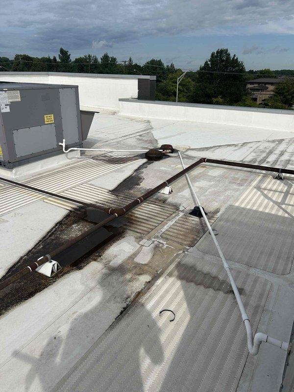 Completed installation of condensate drainage system on commercial flat roof, running new PVC condensate lines from HVAC unit to existing roof drains. Installed approximately 60 feet of PVC pipe with appropriate couplings and support standoffs to ensure proper pitch and drainage flow. Two-hour installation ensures proper condensate removal from rooftop HVAC equipment to prevent water accumulation and potential equipment damage.