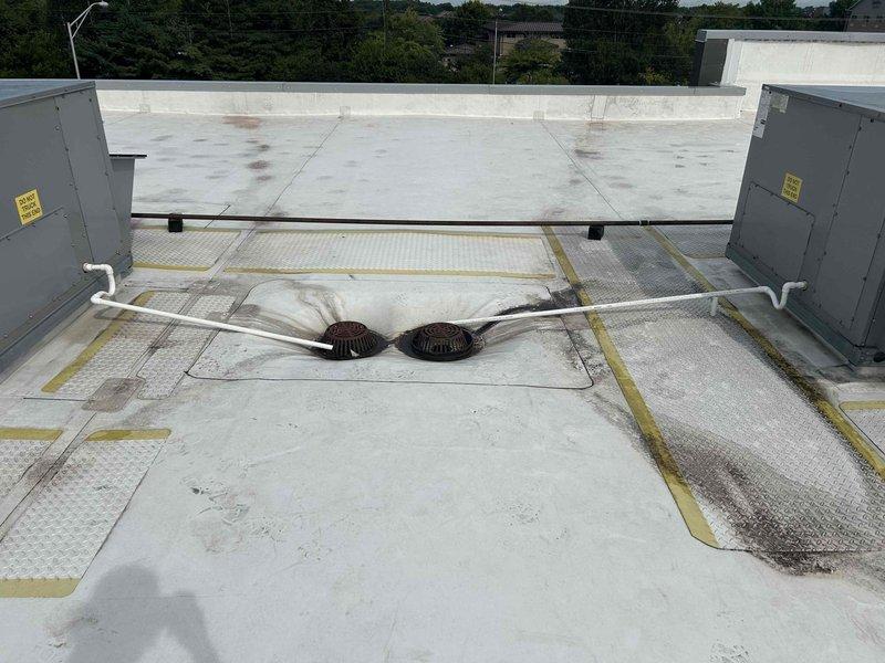 Installed new condensate drainage system on commercial flat roof, running PVC piping from two rooftop HVAC package units to existing roof drains. Utilized approximately six 10-foot sections of PVC pipe with appropriate couplings to create proper drainage pathways across the roofing membrane, ensuring condensate is directed away from equipment and discharged into designated roof drain locations. Work completed in two hours with proper pipe support and secure mounting to prevent damage to roof surface.