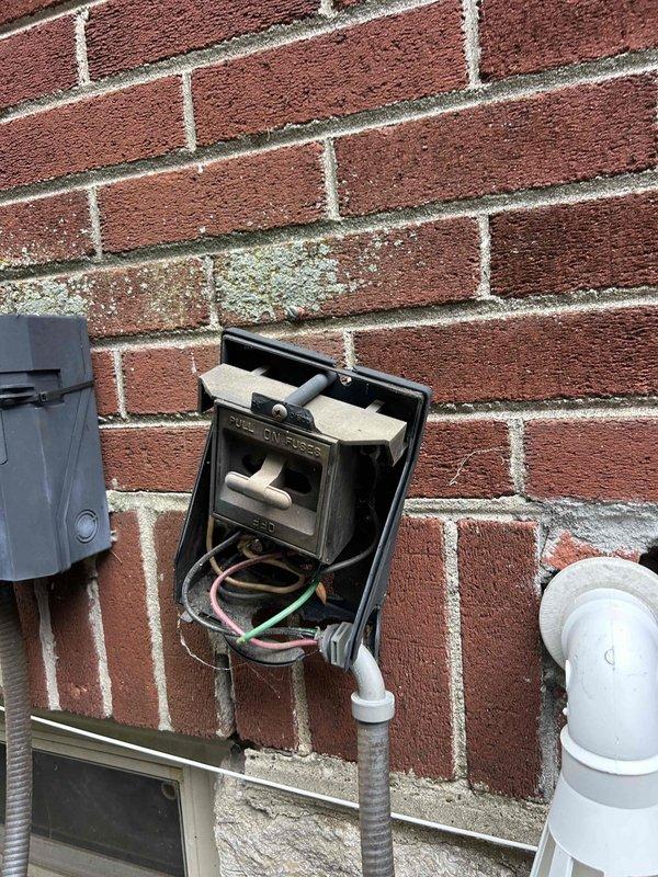 Responded to no cooling call on 12-year-old electric HVAC system. Upon arrival, found exterior electrical disconnect box had been accidentally pulled from brick wall with wiring damaged and disconnected. Reinstalled disconnect box securely to exterior wall, reconnected and properly terminated all electrical wiring including line voltage connections, verified proper polarity and grounding, and restored power to outdoor condensing unit. Tested system operation and confirmed unit returned to normal cooling function with all electrical connections secure and code-compliant.
