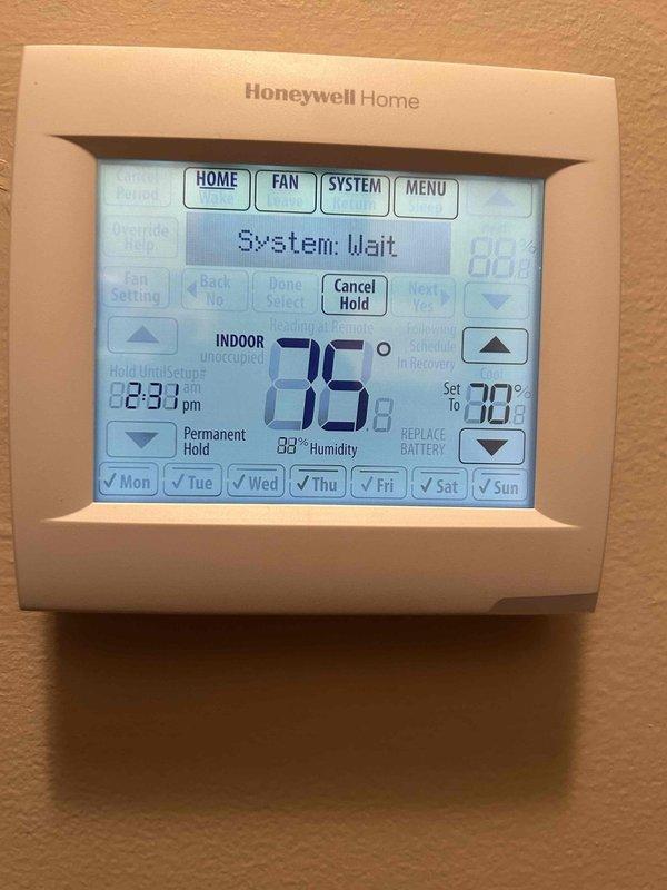 Responded to no cooling call on 4-year-old electric HVAC system with indoor temperature exceeding 80 degrees. Found Honeywell TH8321WF1001 thermostat display completely blank and non-responsive. Diagnosed low battery condition preventing thermostat operation. Replaced thermostat batteries, restored power to unit, and verified proper communication between thermostat and HVAC system. Confirmed system entered normal wait cycle and programmed schedule was intact with proper temperature setpoints. System returned to normal cooling operation with display showing current temperature, humidity readings, and all functions operational.