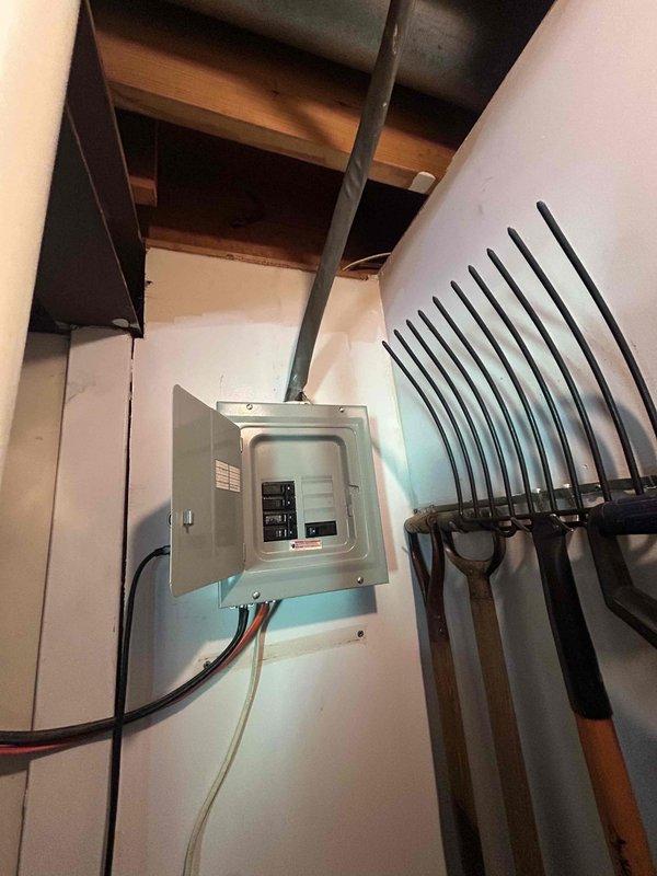 Responded to urgent no-cooling call for one-year-old Trane heat pump system. Inspected main electrical panel and distribution system in basement utility area to verify power supply to outdoor compressor unit. Documented electrical panel configuration and circuit breaker arrangement for whole-house HVAC system. Provided quote for surge protector installation to protect new heat pump equipment from electrical damage.