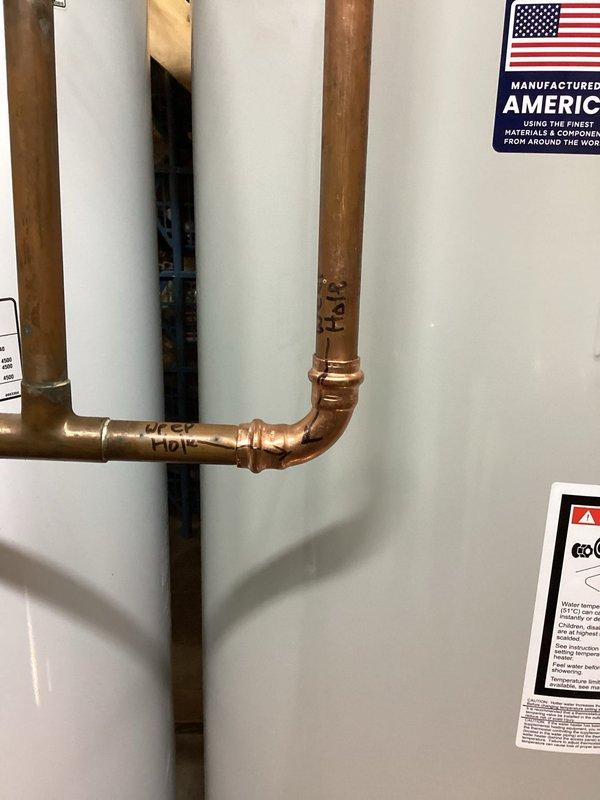 Completed installation of dual water heater system with expansion tank and associated plumbing connections. Installed copper and PVC piping with proper shut-off valves, brass fittings, and electrical disconnect. Follow-up visit scheduled to verify desuperheater pump operation on geothermal system, drill weep hole, and adjust water heater temperature setting per customer preference.