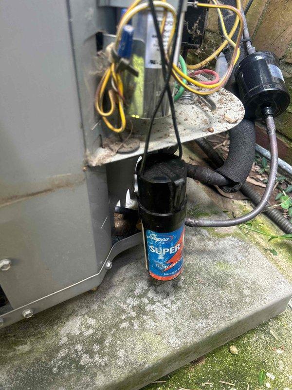 Responded to no-cool complaint on three-year-old air conditioning system. Upon arrival, accessed unit using provided entry code as homeowner was away. Diagnosed failed dual-run capacitor causing compressor and condenser fan motor failure, which also produced abnormal noise reported by customer. Tested capacitor with multimeter, confirming readings of 199 microfarads out of specification range. Replaced defective capacitor with new SuperCo unit, verified proper electrical connections, and tested system operation. Unit restored to normal cooling operation with compressor and fan motor running within manufacturer specifications.