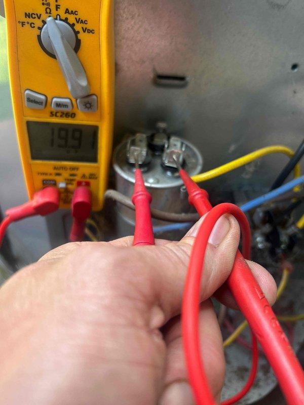 Responded to no-cool complaint on three-year-old air conditioning system. Upon arrival, accessed unit using provided entry code as homeowner was away. Diagnosed failed dual-run capacitor causing compressor and condenser fan motor failure, which also produced abnormal noise reported by customer. Tested capacitor with multimeter, confirming readings of 199 microfarads out of specification range. Replaced defective capacitor with new SuperCo unit, verified proper electrical connections, and tested system operation. Unit restored to normal cooling operation with compressor and fan motor running within manufacturer specifications.