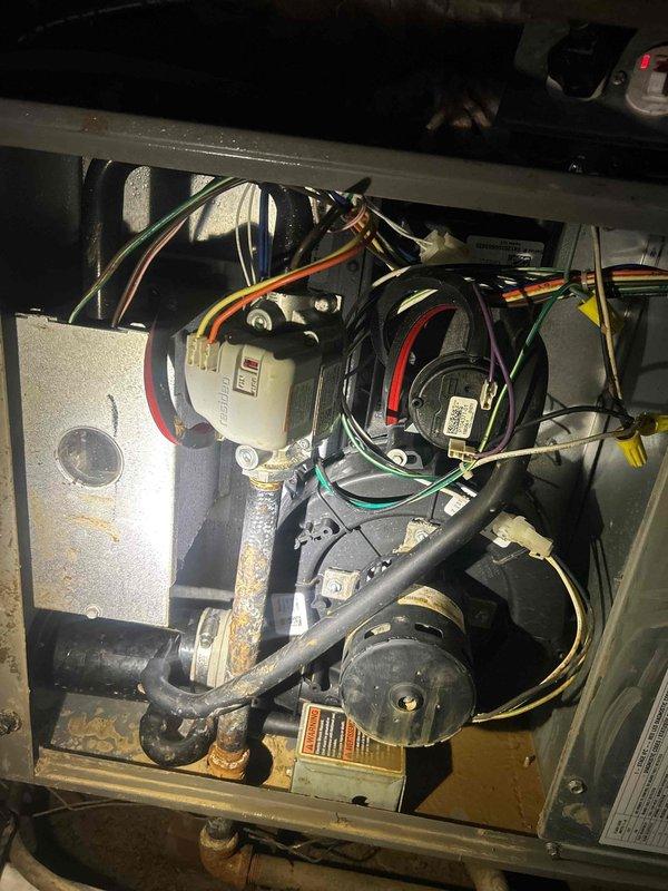 Responded to no cooling complaint on 1-year-old electric HVAC system with no airflow and green flashing light at outdoor unit. Upon inspection, found blower motor assembly failure preventing air circulation through the system. Diagnosed faulty blower motor and capacitor causing complete loss of indoor air movement while thermostat displayed 72°F actual temperature against 68°F setpoint. Accessed indoor unit compartment, disconnected electrical connections, and replaced defective blower motor assembly with OEM equivalent unit. Installed new run capacitor and verified proper wiring connections throughout blower circuit. Tested system operation, confirmed adequate airflow at all registers, and verified proper temperature differential across evaporator coil. System restored to full cooling capacity with normal operation confirmed.