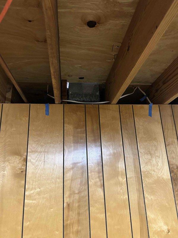 Completed comprehensive electrical estimate for full rewire of residential property currently under renovation. Assessed exposed framing in multiple areas including attic/crawl space and main living spaces where structure has been stripped to studs. Evaluated existing wiring conditions, documented cable routing through floor joists and wall cavities, and identified electrical device locations including mounted equipment between ceiling joists. Photographed current state of electrical infrastructure including visible white and dark-colored conductors running through open wall cavities. Provided detailed assessment for complete electrical system replacement including new circuit routing, device placement, and code-compliant installation throughout the gut-renovated space.