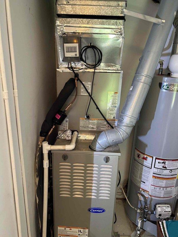 Completed full residential air conditioning system installation including Bryant 2.5 ton up to 17 SEER2 outdoor condensing unit (model GA5SAN53000W) and matching Bryant evaporator coil (model CVAVA3017XMA). Installed outdoor unit on concrete pad with electrical disconnect box and whip kit for proper power supply. Ran and insulated refrigerant lines from outdoor condenser to indoor evaporator coil, installed refrigerant line filter drier for system protection. Mounted evaporator coil in existing air handler cabinet with proper transitions to existing ductwork. Installed SS2 coil drain safety water sensor to prevent overflow damage. Removed and properly disposed of existing equipment per environmental regulations. Pulled all applicable permits and completed installation to current code compliance standards. Evacuated refrigerant lines, charged system to manufacturer specifications, and performed complete operational testing to verify proper cooling performance, airflow, and safety contro