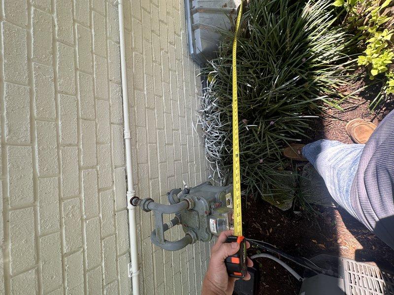 Conducted comprehensive site assessment for backup generator installation at residential property. Measured and documented existing gas meter assembly location and height to determine optimal placement and connection points for generator unit. Evaluated electrical service panel accessibility and documented current outdoor electrical infrastructure to ensure proper integration with automatic transfer switch requirements.