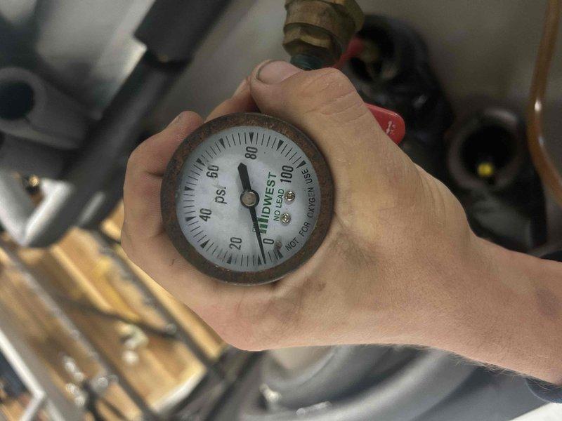 Completed Gold Level annual preventative maintenance on single-system HVAC unit. Performed comprehensive system diagnostics including electrical testing with multimeter showing 12.4 amp draw and pressure testing with gauge reading at zero PSI. Inspected copper refrigerant lines, brass fittings, and associated piping components to ensure proper operation and system integrity.