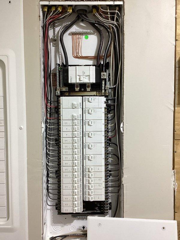 Completed comprehensive electrical estimate for generator installation at residential property. Documented existing electrical infrastructure including main service panel with dual-row circuit breaker configuration, copper bus bar assembly, and exterior meter base with adjacent distribution panel. Assessed current electrical system capacity, panel conditions, and optimal integration points for proposed generator transfer switch and associated wiring requirements.