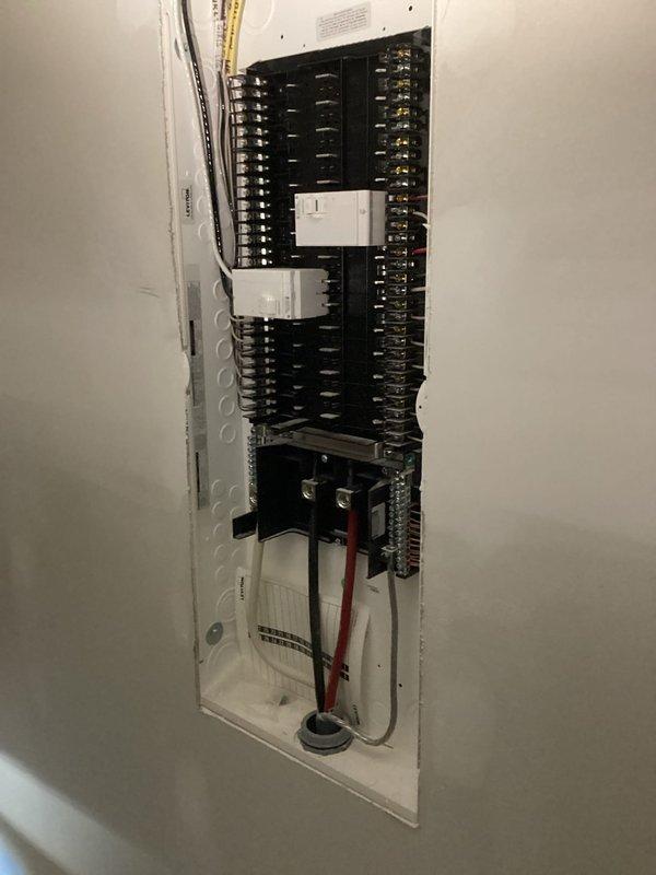 Conducted comprehensive electrical estimate for Kohler generator installation at residential property. Evaluated existing electrical infrastructure including main distribution panel with current circuit breaker configuration, surge protection devices, and service entrance wiring. Assessed secondary electrical panels in unfinished area with exposed framing to determine integration points for automatic transfer switch and generator connection. Documented wire routing pathways, panel capacity, available breaker slots, and conduit entry points necessary for generator tie-in. Photographed current electrical system configuration to develop accurate scope of work and material requirements for complete standby generator installation.