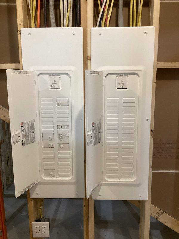 Conducted comprehensive electrical estimate for Kohler generator installation at residential property. Evaluated existing electrical infrastructure including main distribution panel with current circuit breaker configuration, surge protection devices, and service entrance wiring. Assessed secondary electrical panels in unfinished area with exposed framing to determine integration points for automatic transfer switch and generator connection. Documented wire routing pathways, panel capacity, available breaker slots, and conduit entry points necessary for generator tie-in. Photographed current electrical system configuration to develop accurate scope of work and material requirements for complete standby generator installation.