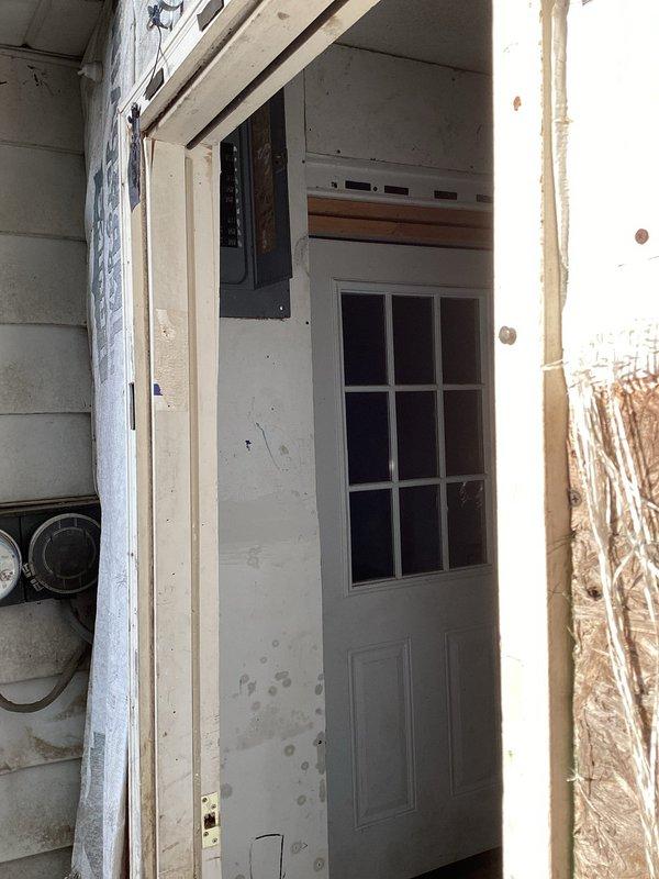 Relocated electrical service mast to achieve proper clearance height as required by utility company specifications. The existing service line from the transformer to the residence was determined to be below minimum code requirements, necessitating repositioning of the weatherhead and mast assembly to ensure safe overhead conductor clearance and compliance with power authority standards.