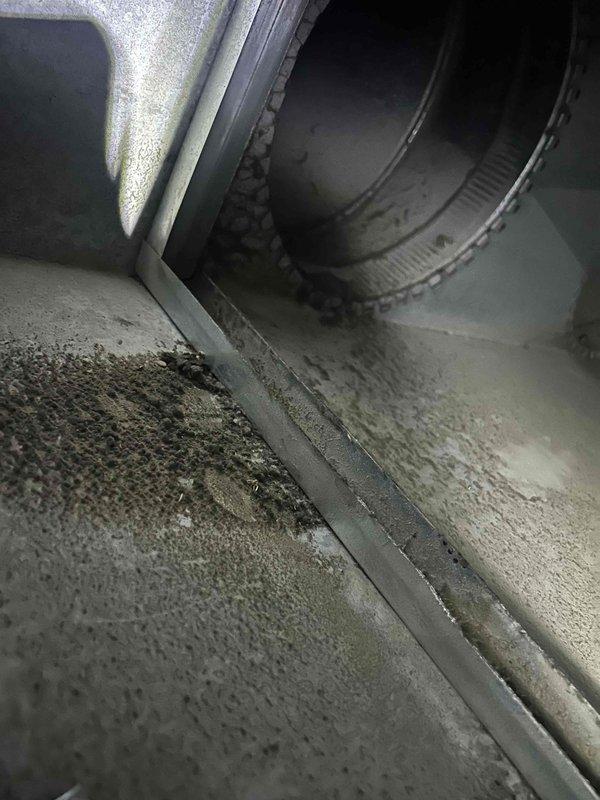Responded to no cooling complaint on 3-year-old attic-mounted air conditioning system. Upon arrival, found thermostat displaying 83°F with system running in cooling mode but failing to achieve setpoint. Inspected air handler unit in attic and confirmed reported melted foam insulation component within the cabinet. Examined evaporator coil assembly, ductwork connections, and internal components for additional damage or airflow restrictions. Documented conditions with photographs showing dust accumulation on interior surfaces and melted insulation material. System requires replacement of damaged insulation component and further diagnostic evaluation to determine root cause of overheating and cooling failure.