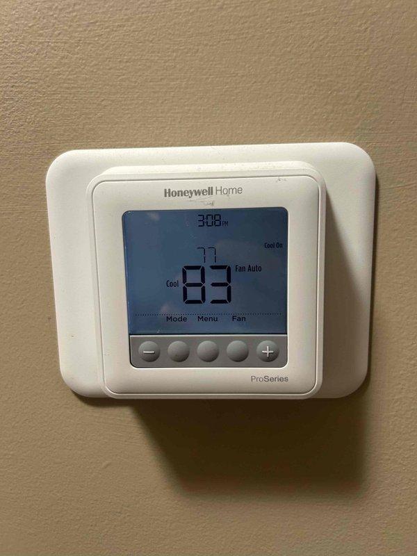 Responded to no cooling complaint on 3-year-old attic-mounted air conditioning system. Upon arrival, found thermostat displaying 83°F with system running in cooling mode but failing to achieve setpoint. Inspected air handler unit in attic and confirmed reported melted foam insulation component within the cabinet. Examined evaporator coil assembly, ductwork connections, and internal components for additional damage or airflow restrictions. Documented conditions with photographs showing dust accumulation on interior surfaces and melted insulation material. System requires replacement of damaged insulation component and further diagnostic evaluation to determine root cause of overheating and cooling failure.