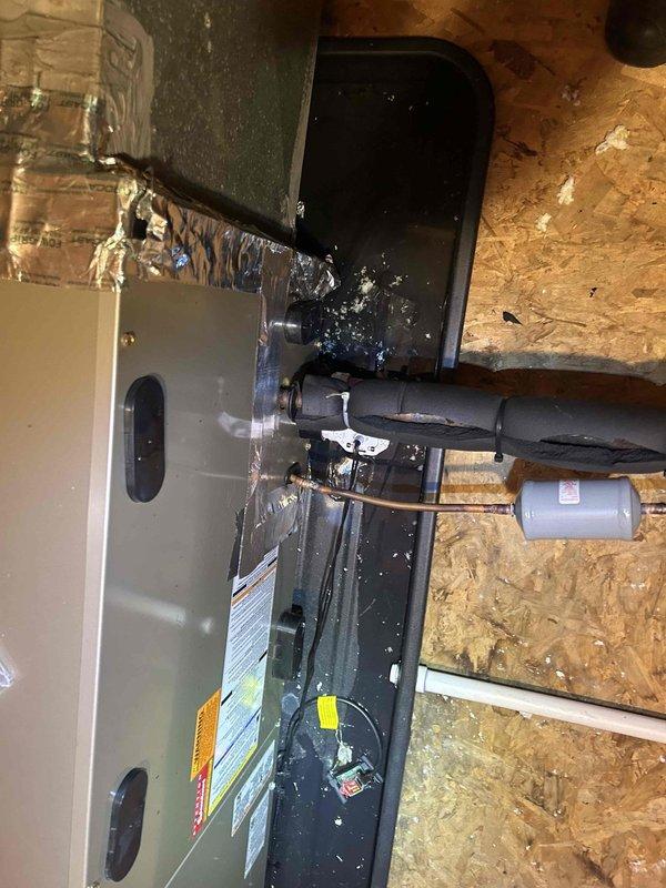 Responded to no cooling call for 3-year-old heat pump system. Upon arrival, confirmed thermostat had no power and display was blank. Performed diagnostic testing on HVAC system components in attic location. Traced low voltage wiring from air handler to thermostat, checking transformer output voltage and circuit continuity. Identified power supply issue preventing thermostat operation. Completed necessary repairs to restore 24V power to thermostat circuit. Verified air handler and heat pump operation, confirmed system cooling properly and thermostat functioning normally. All equipment covered under existing parts and labor warranty. System returned to normal operation with cooling restored.