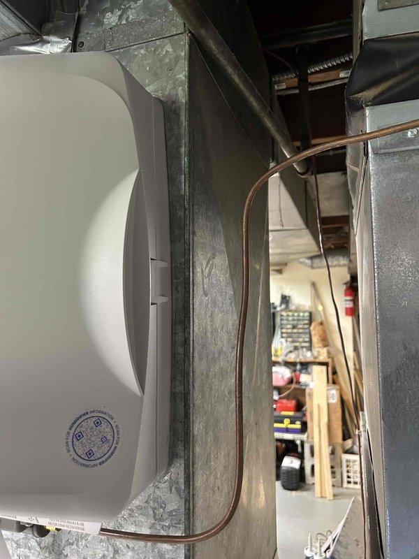 Installed a fan-powered humidifier on the existing forced-air furnace system. Connected the unit to the main supply ductwork, established proper drainage to the condensate pan, and wired the humidistat for automatic operation. Customer will remit payment by check.