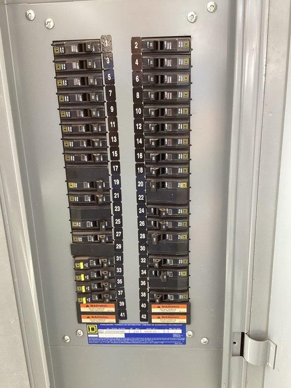 Conducted comprehensive electrical assessment for generator replacement evaluation. Inspected existing electrical infrastructure including main distribution panel containing 42-circuit breaker configuration with proper numerical sequencing and warning labels intact. Panel showed good overall condition with clean installation and proper circuit identification.

Evaluated outdoor electrical disconnect serving existing equipment, which contained BUSS-brand fuse blocks with cartridge fuses and associated terminal connections. Assessed adequacy of existing wiring configuration including conductor sizing and routing through wall penetrations. Noted condition of refrigerant line set and associated HVAC electrical service connection to determine compatibility requirements for potential generator installation.

Documented electrical service capacity, disconnect specifications, and available connection points to provide accurate specifications for both air-cooled and liquid-cooled generator repl