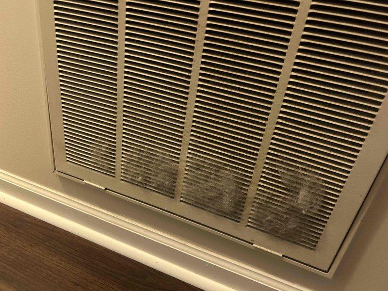 Responded to no cooling complaint on 4-year-old electric upstairs HVAC system with intermittent power loss to air handler and thermostat display going dark. Accessed attic-mounted air handler unit via ladder and inspected electrical connections, control board, and safety switches. Found condensate float switch triggering system shutdown due to primary drain line restriction. Cleared drain blockage, verified proper condensate drainage, and tested float switch operation. Cycled system through multiple cooling cycles to confirm proper operation with no further shutdowns. Inspected return air grille showing significant dust accumulation and recommended air filter replacement schedule adherence. System restored to normal operation with thermostat display functioning and unit cooling properly.