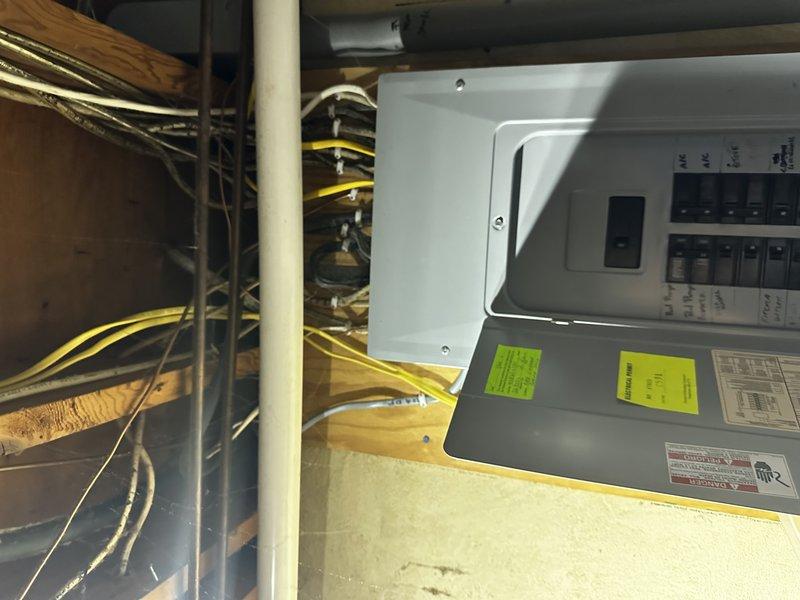 Completed comprehensive electrical estimate for whole-house generator installation at residential property. Assessed existing electrical infrastructure including main service panel located in attic space with current circuit breaker configuration and wiring pathways. Evaluated natural gas meter assembly and supply line capacity mounted on exterior brick wall to determine feasibility for generator fuel source connection. Documented all necessary components including transfer switch requirements, load calculations for essential circuits, gas line sizing specifications, and optimal generator placement considerations. Provided detailed photographic documentation of existing electrical panel, available installation space, and gas utility connection point to develop accurate material list and labor requirements for full generator system integration.