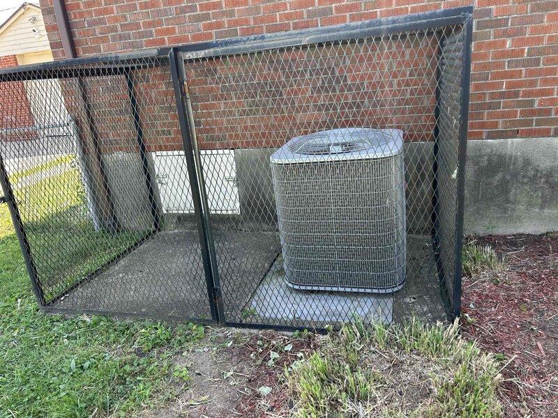 Responded to service call for system blowing warm air through vents despite cold air present at crawlspace unit. Upon arrival, inspected outdoor condenser unit and found it properly secured within protective cage against building exterior. Conducted internal system inspection revealing significant accumulation of dust, debris, and fibrous material within ductwork and air handler components, indicating extended period without maintenance. Documented equipment condition showing deteriorated interior surfaces with lint and particulate buildup affecting airflow distribution, which explained temperature differential between supply air at unit and delivery through registers.