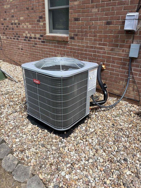 Completed full residential heat pump system installation including Bryant 3.5 ton 14.3 SEER2 single-stage outdoor heat pump unit (model GH5SAN54200A), Bryant 3.5 ton air handler (model FJ5ANXC42L00), and Bryant 20kW auxiliary electric heat kit (model TU-EC-20BKB). Installed Honeywell digital WiFi auto-changeover thermostat (model H6220WF2006/U) for system control. Removed and properly disposed of existing HVAC equipment per code requirements.

Outdoor unit positioned on gravel pad with snow legs for elevation and drainage. Installed electrical disconnect box and whip kit for proper power supply and code compliance. Ran refrigerant lines with new Arma Flex insulation from outdoor unit to indoor air handler, including refrigerant line filter for system protection. Mounted electrical components including junction boxes and conduit along exterior brick wall with professional wire management.

Indoor air handler installation included SS2 coil drain safety water sensor and trap for condensat