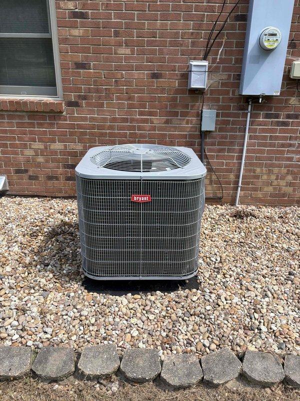 Completed full residential heat pump system installation including Bryant 3.5 ton 14.3 SEER2 single-stage outdoor heat pump unit (model GH5SAN54200A), Bryant 3.5 ton air handler (model FJ5ANXC42L00), and Bryant 20kW auxiliary electric heat kit (model TU-EC-20BKB). Installed Honeywell digital WiFi auto-changeover thermostat (model H6220WF2006/U) for system control. Removed and properly disposed of existing HVAC equipment per code requirements.

Outdoor unit positioned on gravel pad with snow legs for elevation and drainage. Installed electrical disconnect box and whip kit for proper power supply and code compliance. Ran refrigerant lines with new Arma Flex insulation from outdoor unit to indoor air handler, including refrigerant line filter for system protection. Mounted electrical components including junction boxes and conduit along exterior brick wall with professional wire management.

Indoor air handler installation included SS2 coil drain safety water sensor and trap for condensat