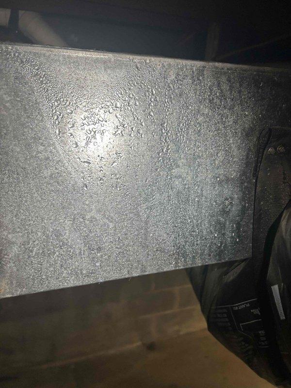 Completed preventative maintenance on gas furnace and air conditioning system located in basement. Inspected and verified proper operation of burners with blue flame combustion pattern. Observed significant condensation buildup on air handling unit exterior, indicating potential insulation or airflow concerns. Evaluated humidifier system and confirmed need to assess steam humidifier canister condition for potential replacement. Installed customer-supplied 16x20x4 air filter. System operational at time of departure.