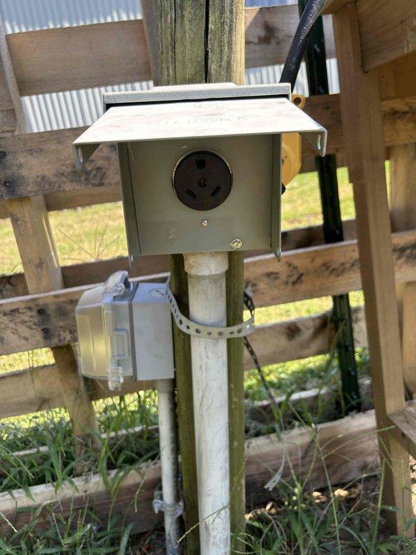 Performed electrical inspection of outdoor RV/camper service panel and discovered improper meter installation. The existing meter is rated for mobile home use rather than camper application, creating a code compliance and safety issue. The current configuration includes a weatherproof outlet box mounted on PVC post with multiple circuit breakers and copper bus bars inside the main panel enclosure. Recommended complete rewiring of the camper meter installation to meet proper electrical standards and ensure safe operation for the intended RV/camper application.