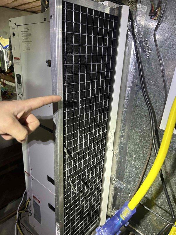 Completed annual maintenance on residential geothermal HVAC system consisting of two geothermal units, one air handler located in attic, and one humidifier as part of recurring service agreement. Performed comprehensive inspection of air handler unit with visual assessment of cabinet condition, filter housing, and ductwork connections. Conducted diagnostic testing using digital multimeter to verify operational parameters, recording temperature differential of -1.8 degrees. Inspected blower motor assembly, heat exchanger components, and electrical connections including wire terminations and safety controls. Verified proper operation of condensate drainage system with yellow flexible drain line and blue fittings. All equipment found operating within normal parameters with no deficiencies noted. System performing as designed with proper airflow through ductwork and satisfactory component function throughout attic-mounted installation.