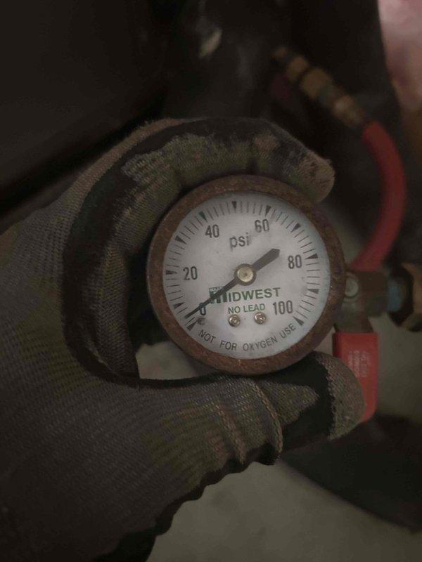 Completed routine HVAC maintenance inspection in basement mechanical space. Performed system diagnostics including pressure testing with gauge readings indicating approximately 40 PSI, inspected flexible ductwork for proper installation and condition, and serviced washable filter. All components found operating within normal parameters with no immediate repairs required.