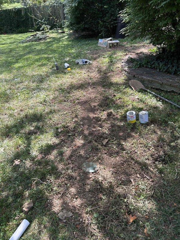 Relocated sump pump discharge system by capping the existing discharge line that was tied into the sewer system and installing a new 1.5-inch PVC discharge line through the foundation wall to the backyard. Trenched approximately 30 feet through the yard, carefully routing around existing deck post locations to accommodate future deck construction, and terminated the line at a pop-up emitter. Utilized a Ditch Witch trencher for excavation work, backfilled and graded the trench to minimize surface disruption. Verified proper pump operation and confirmed all connections were leak-free upon completion.