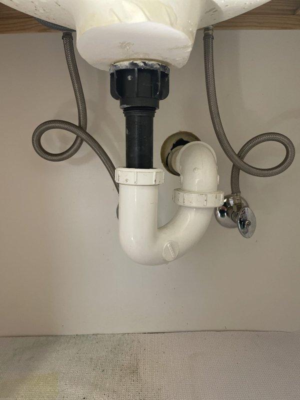 Completed tub faucet cartridge replacement including O-ring installation to eliminate leak, requiring main water supply shut-off during repair. Addressed slow-draining tub by removing red cap inadvertently left on overflow during previous fixture installation; drain continues to flow slowly and requires professional drain cleaning service. Installed customer-supplied lavatory faucet in jack and jill bathroom, connecting new supply lines and drain assembly as shown in completion photos.