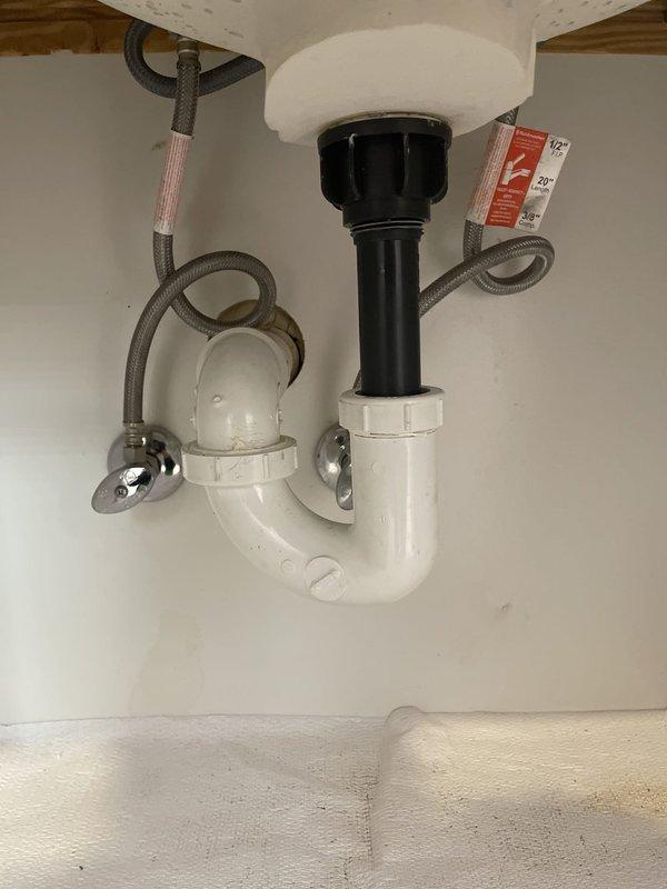 Completed tub faucet cartridge replacement including O-ring installation to eliminate leak, requiring main water supply shut-off during repair. Addressed slow-draining tub by removing red cap inadvertently left on overflow during previous fixture installation; drain continues to flow slowly and requires professional drain cleaning service. Installed customer-supplied lavatory faucet in jack and jill bathroom, connecting new supply lines and drain assembly as shown in completion photos.