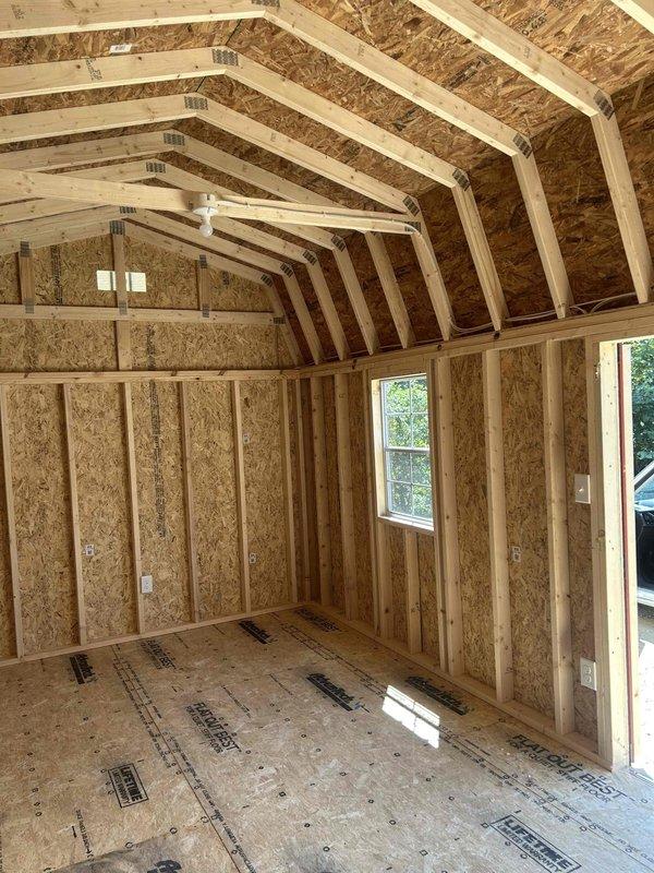 Completed full electrical wiring installation in 10x26 outbuilding structure, installing 100-amp main service panel with breakers, GFCI outlet, duplex receptacles, single-pole switch, and keyless light fixture with bulb. Ran all necessary branch circuits through exposed framing, mounted panel centrally on OSB wall with proper conduit connections, and installed outlet boxes per code requirements. All electrical components tested and verified operational upon completion.