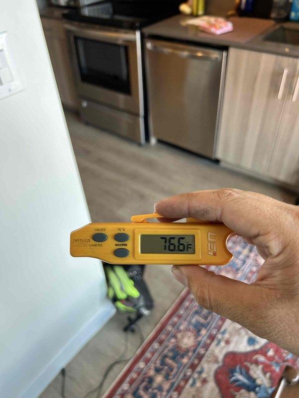 Responded to no cooling complaint on LG Dual Inverter ductless mini-split system in commercial space. Upon arrival, verified unit was operational but not maintaining desired temperature setpoint. Measured ambient room temperature at 76.6°F using calibrated digital thermometer. Inspected indoor wall-mounted air handler for proper airflow and operational status. System appeared to be running but not achieving adequate cooling capacity. Documented equipment condition and temperature readings for diagnostic evaluation.